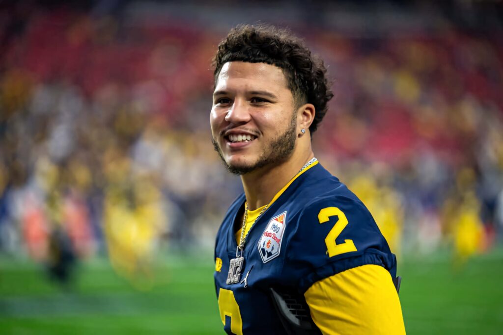 Blake Corum in Michigan football uniform number 2 smiling energetic inspiring wallpaper background