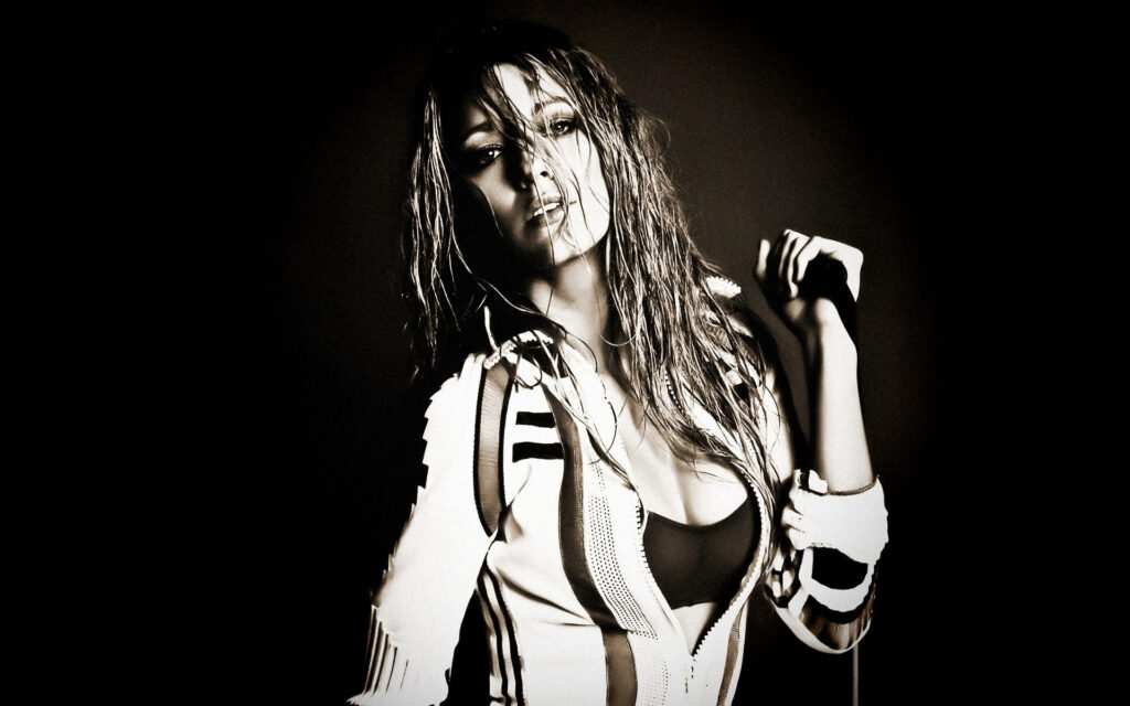 Blake Lively with wet hair confident pose against dramatic dark background stylish wallpaper