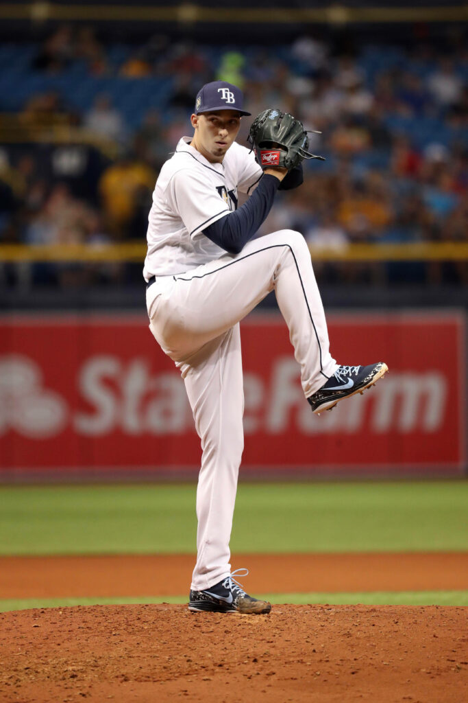 Blake Snell pitching on mound with leg raised focused form during baseball game wallpaper background