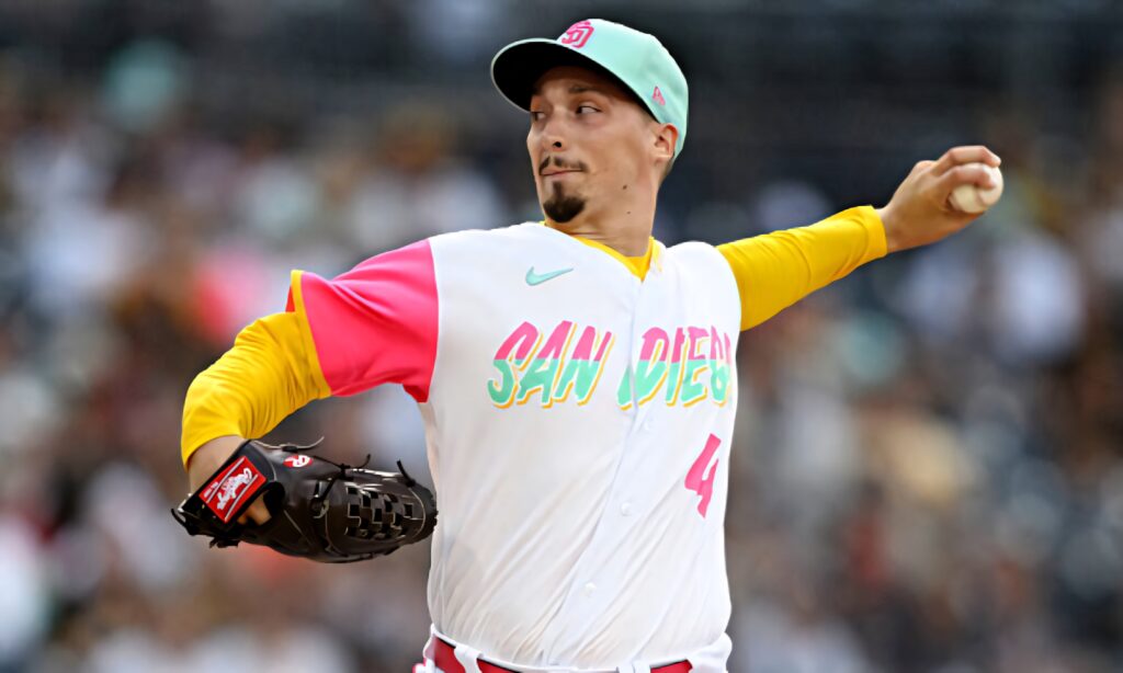 Blake Snell pitching in vibrant San Diego Padres pink yellow aqua uniform wallpaper background