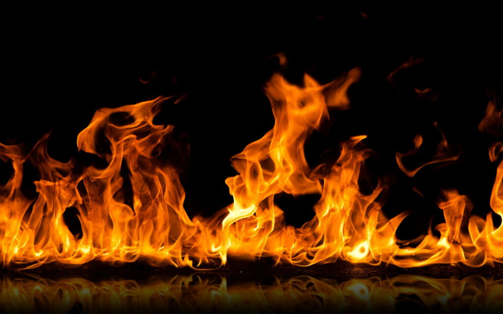 Vibrant orange yellow dancing flames blazing against black background HD bonfire wallpaper