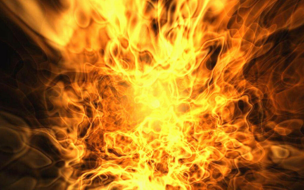 Blazing Inferno wallpaper with glowing yellow orange flames swirling in dynamic fiery explosion
