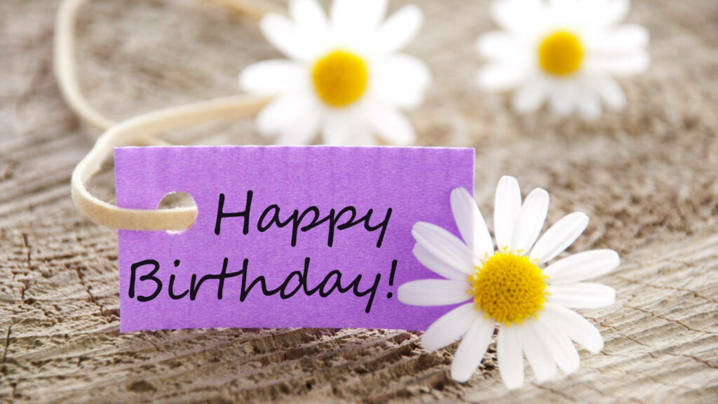 Blooming Delight: A Cheerful Happy Birthday Tag Adorned with Petite White Daisy Blossoms Wallpaper