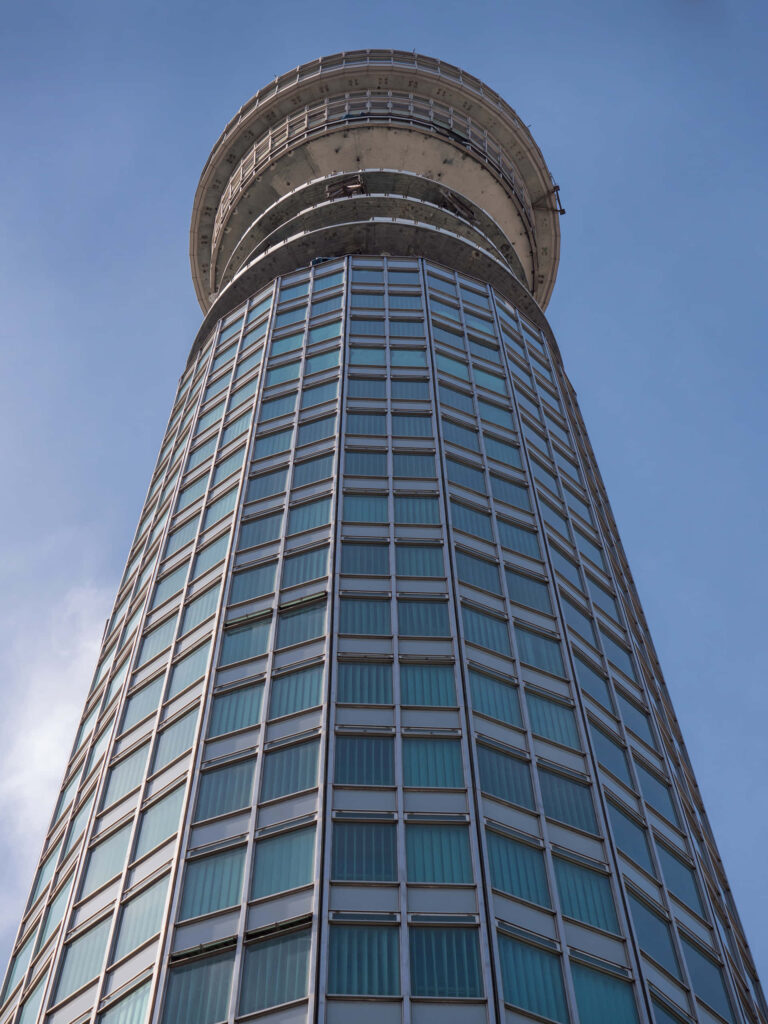 Upward view of BT Tower glass steel architecture blue sky tech cityscape wallpaper background