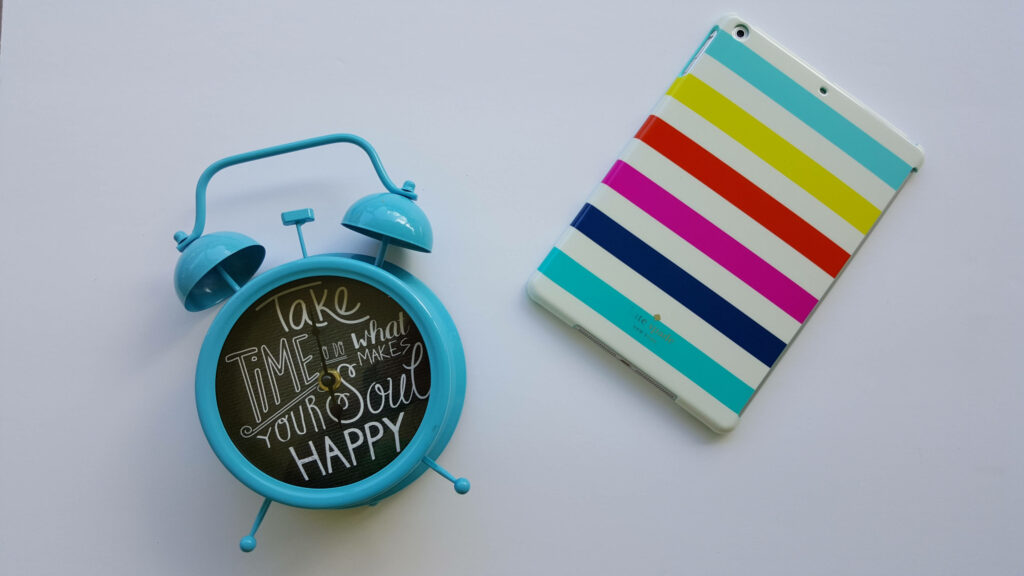 Blue Alarm Clock with Motivational Quote on Clean White Background Wallpaper