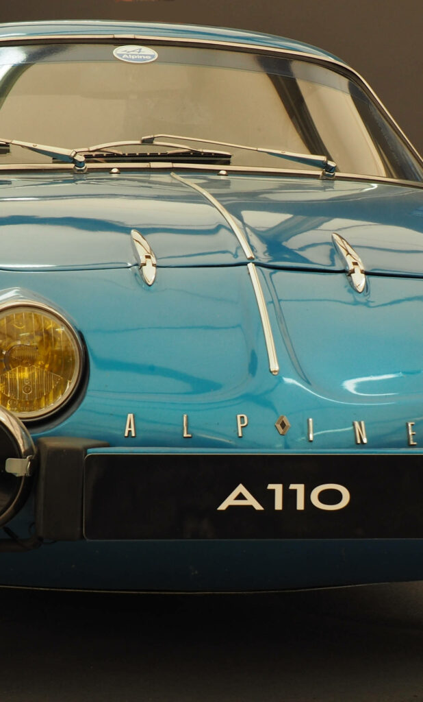 Front view of vintage Blue Alpine A110 car with iconic headlights wallpaper background
