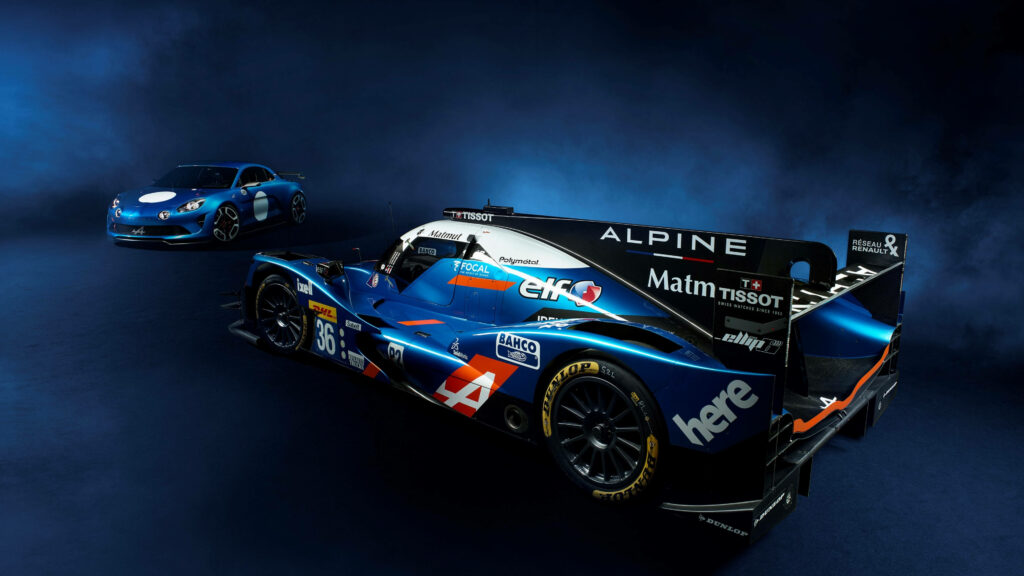 Two blue Alpine cars on smoky dark background showcasing sleek design and racing spirit wallpaper