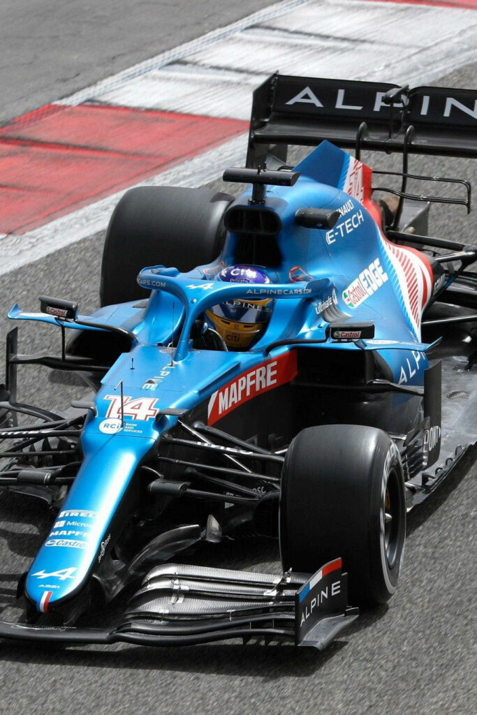 Blue Alpine Formula 1 car racing fast with sleek design and vibrant livery on racetrack wallpaper