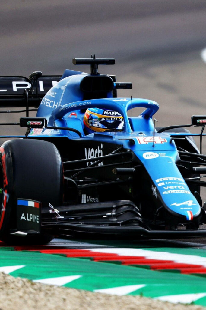 Blue Alpine Formula 1 car racing fast on track showcasing high-performance motorsport action Wallpaper