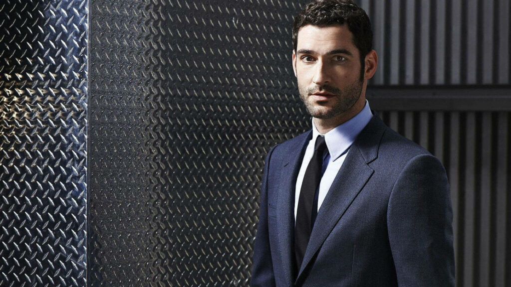 Sophisticated Tom Ellis in Blue Suit on Metallic Background - Lucifer Series Celebrity Image Wallpaper