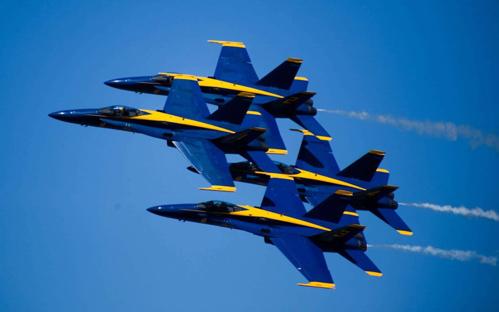 US Air Force Blue Angels flying precise blue and yellow jets in clear blue sky formation Wallpaper