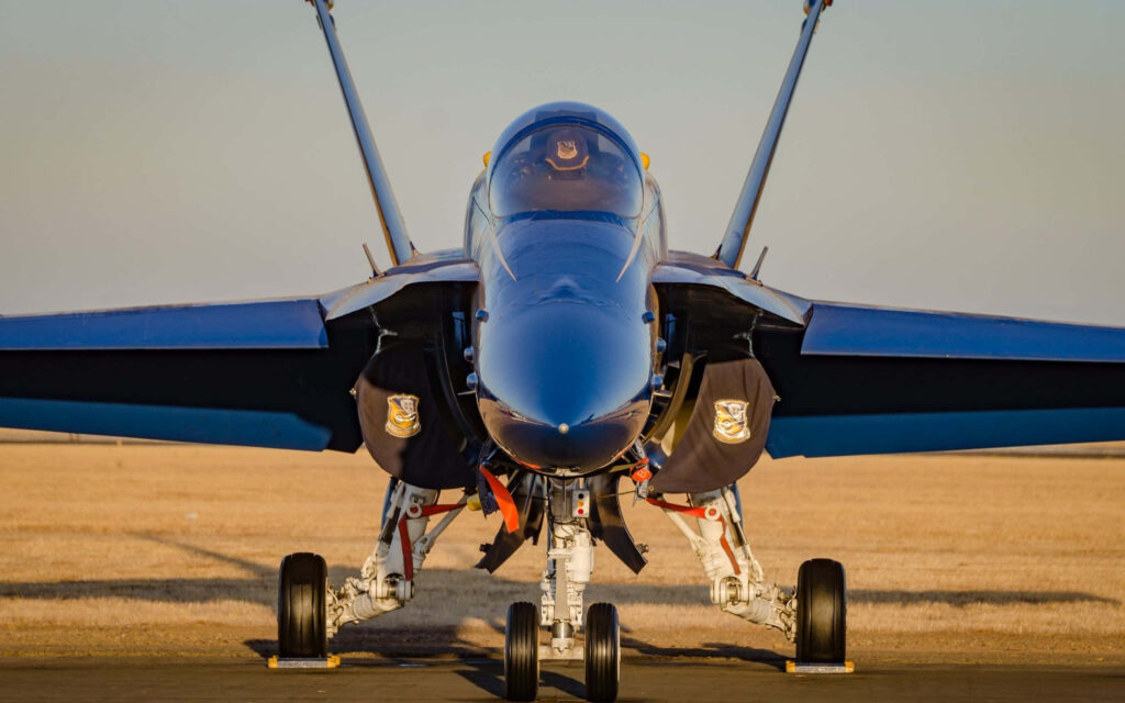 Blue Angels fighter jet front view on runway showcasing US Navy precision and power wallpaper