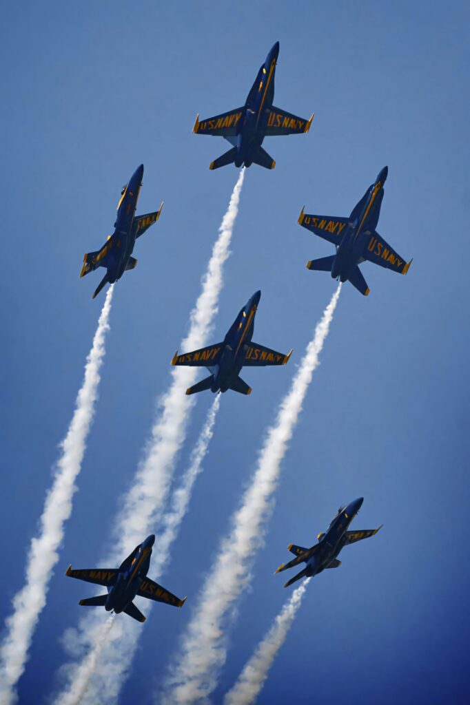 Blue Angels US Navy jets in perfect formation with white trails against clear blue sky wallpaper