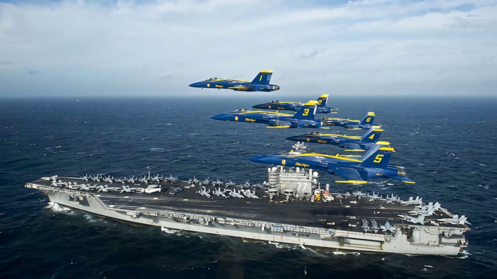 Blue Angels jets flying in formation over USS George HW Bush aircraft carrier at sea wallpaper