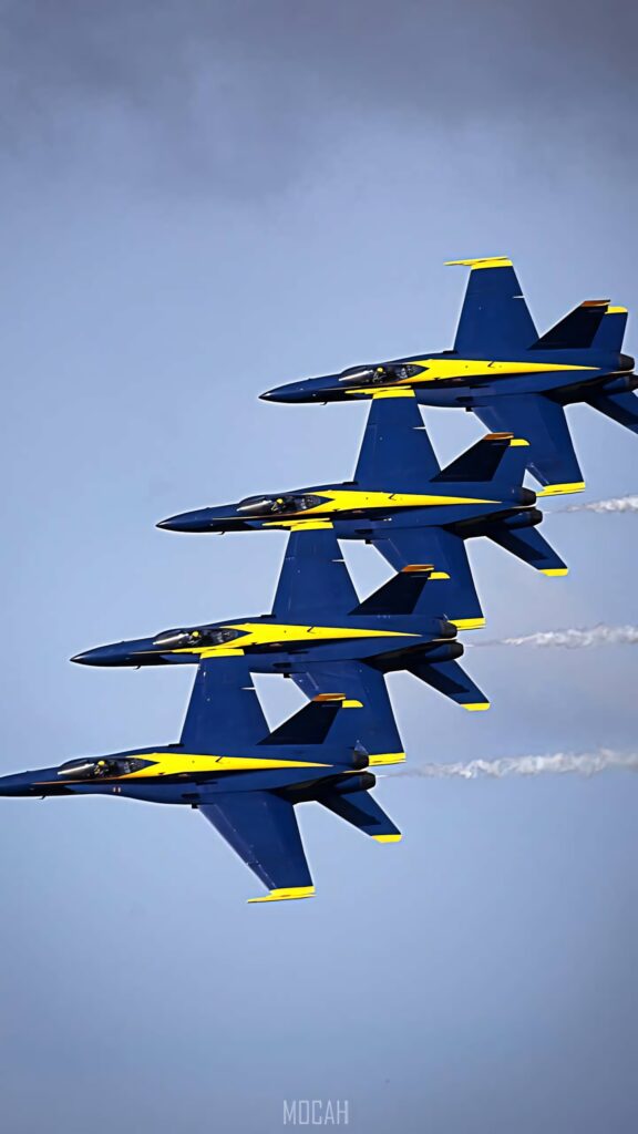 Four Blue Angels jets flying in tight formation against clear sky dynamic aerial team wallpaper