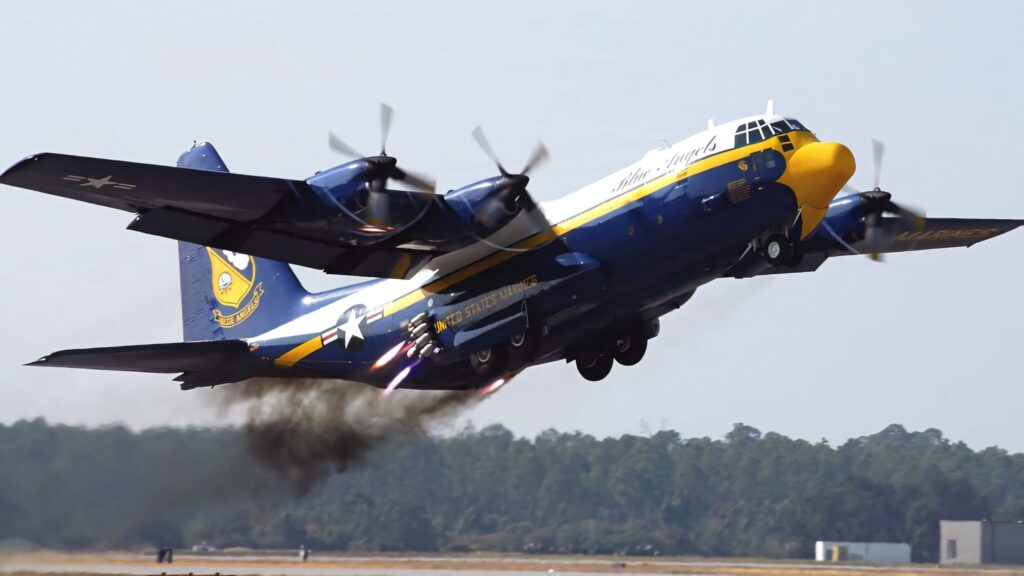 Blue Angels Lockheed C130 Hercules aircraft blue and yellow livery taking off against sky Wallpaper