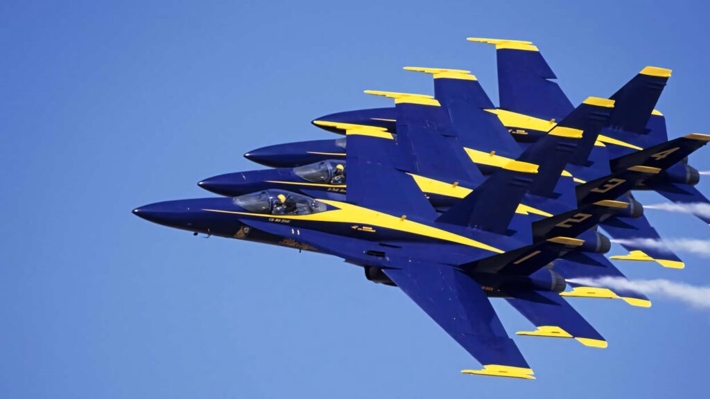 Blue Angels flight team soaring in tight formation against clear blue sky wallpaper background