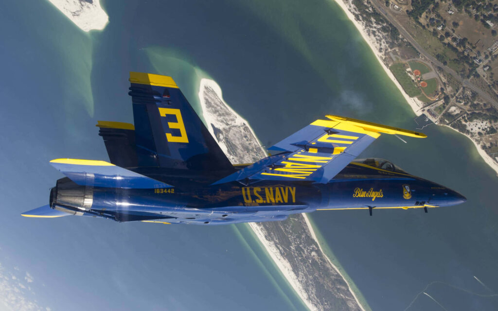 Blue Angels Navy jet soaring above coastline in precision flight formation wallpaper background