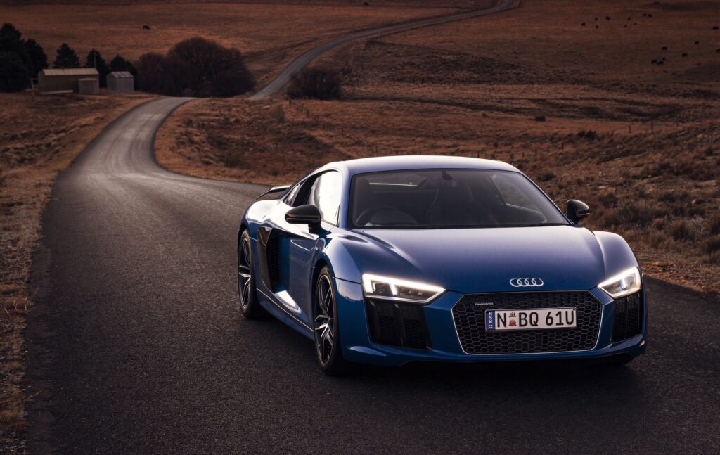 Blue Audi R8 V10 in Motion: Scenic Winding Road Wallpaper