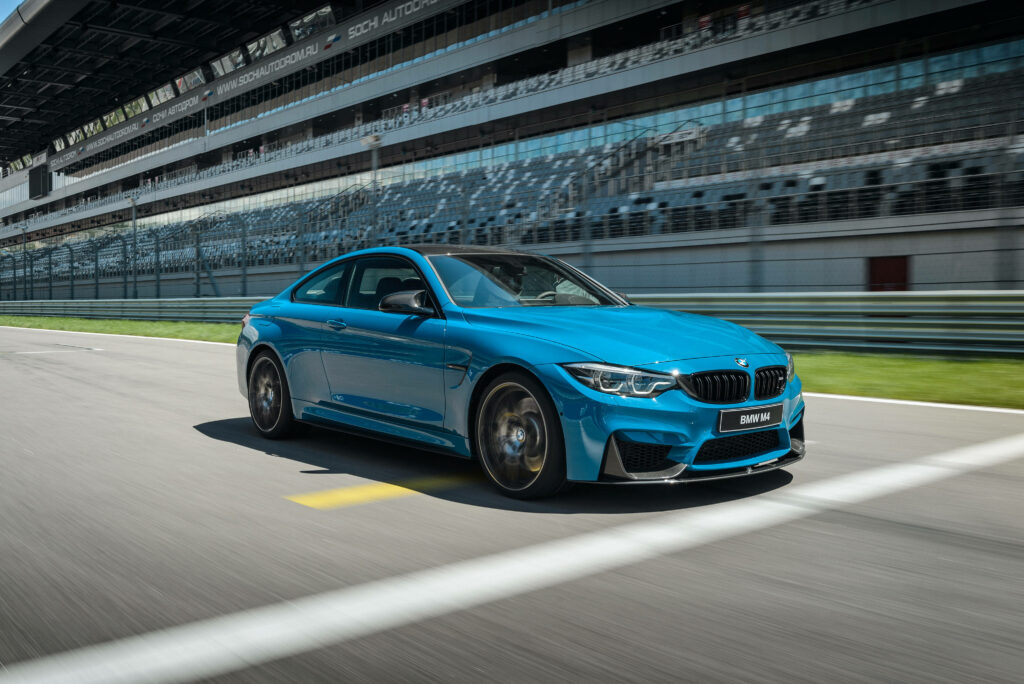 Blue Lightning: Capturing the Speed and Elegance of a BMW M4 Coupé on an Empty Racing Circuit Wallpaper