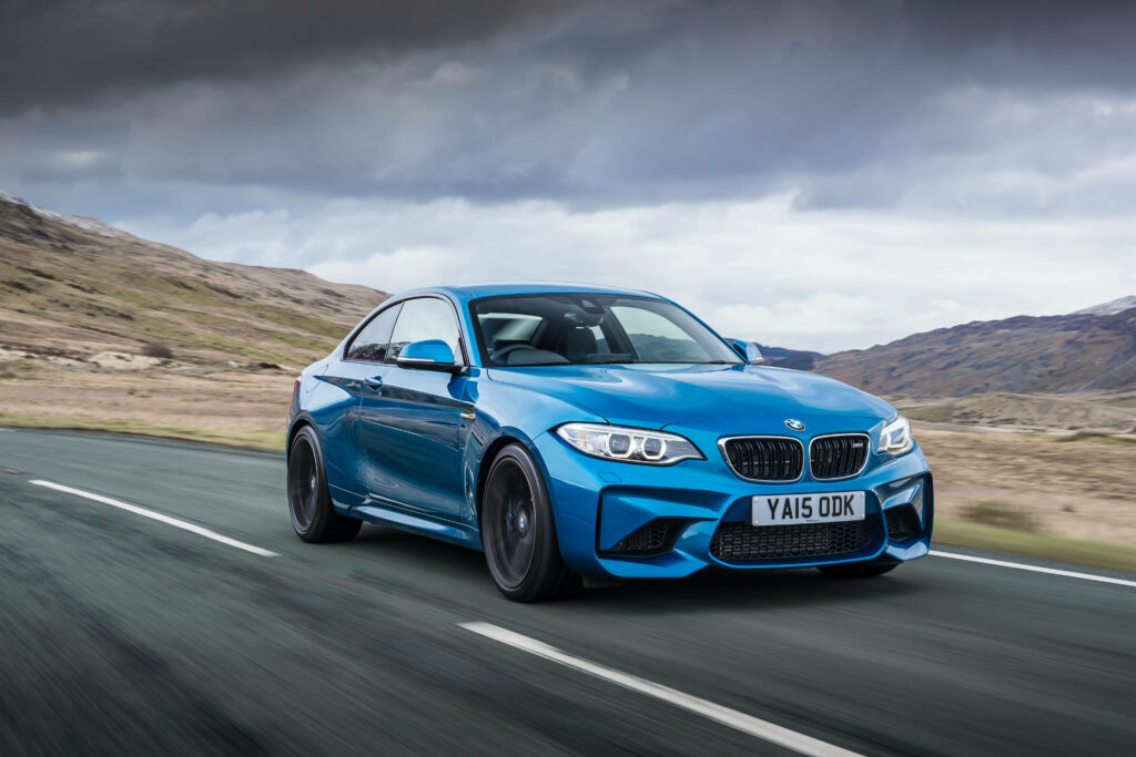 Blue Thunder: A 4K BMW Speeding Through the Daytime Highway Wallpaper