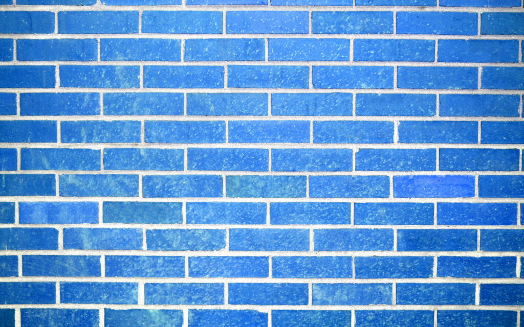 Symmetrical Serenity: Exploring Subtle Depths of Blue Brickwork in High-Quality QHD Wallpaper