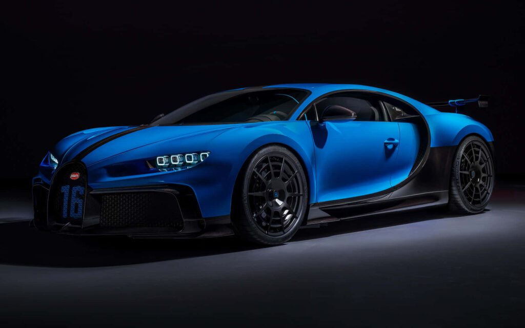 Blue Bugatti Chiron sports car with aerodynamic curves on dark luxury wallpaper background