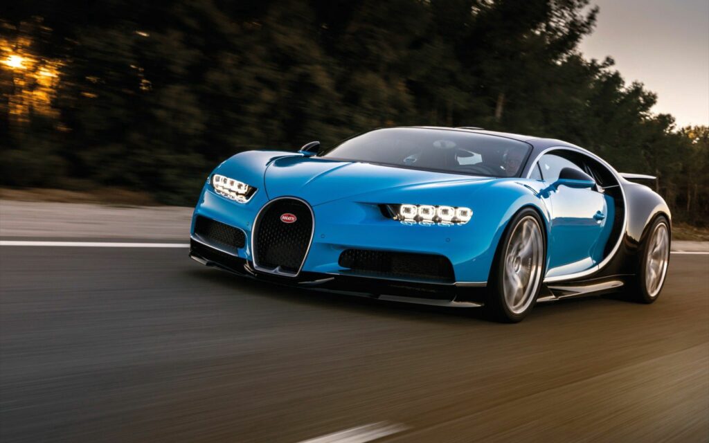 Stunning Blue Bugatti Chiron in Motion on Scenic Road Wallpaper