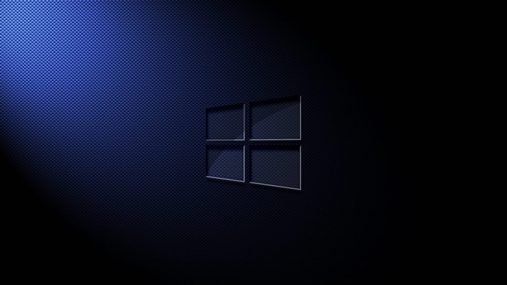 Blue carbon fiber Windows logo wallpaper with sleek dark background and modern tech design