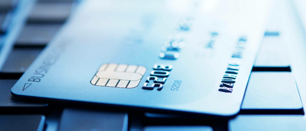 Close-up of blue credit card on keyboard representing online payment and digital finance technology Wallpaper