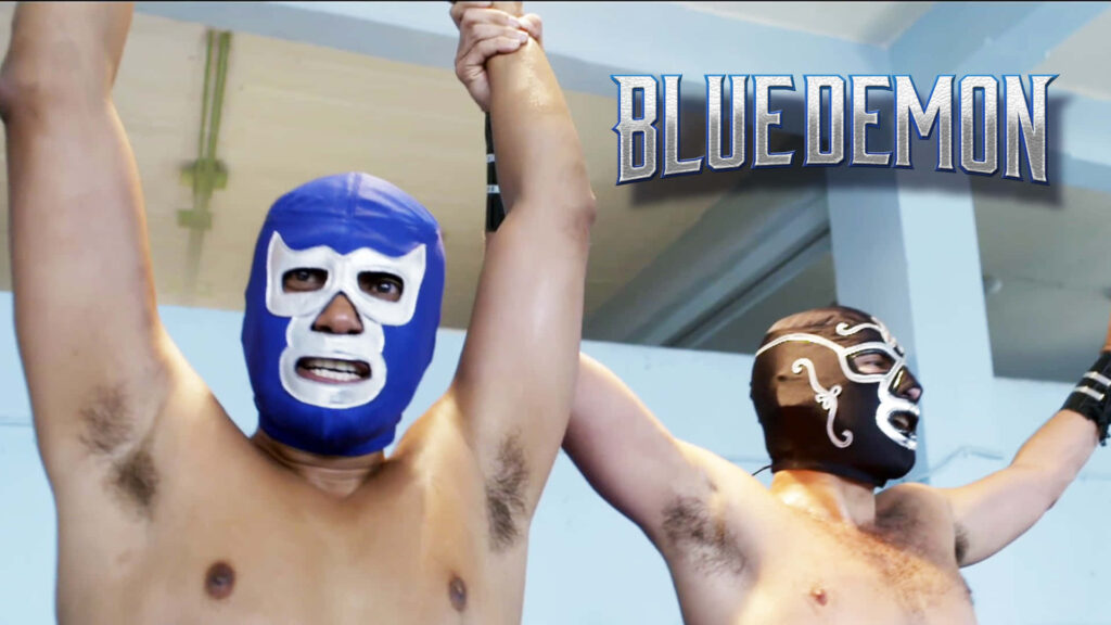 Blue Demon wrestler in iconic blue mask victorious in ring classic lucha libre wallpaper background