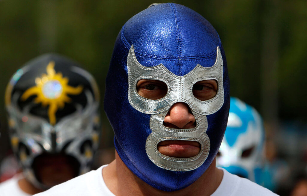 Person wearing classic Blue Demon style blue and silver lucha libre wrestling mask wallpaper background
