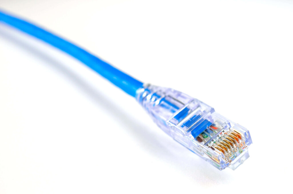 Close-up of blue Ethernet cable with clear connector showing detailed wires on white background Wallpaper