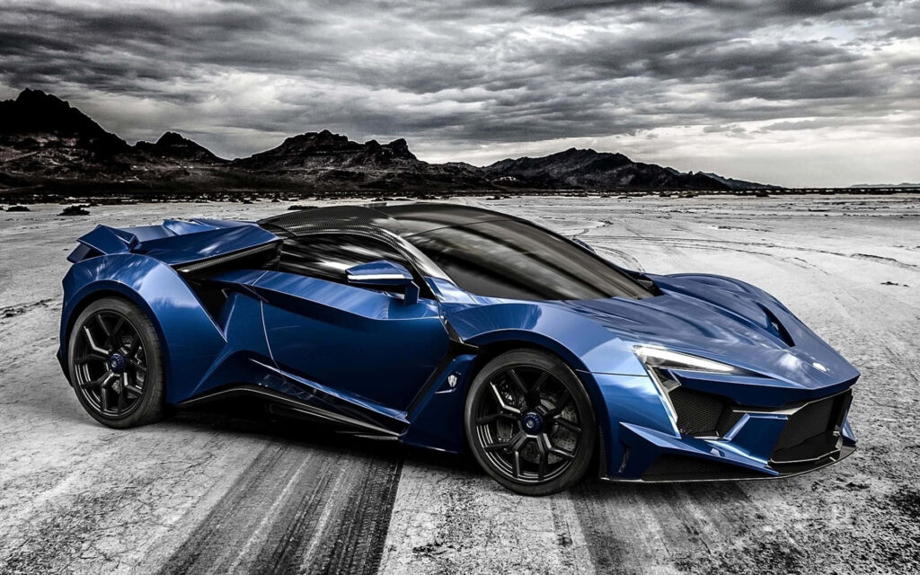 Blue Fenyr Supersport sports car under dramatic stormy sky on open landscape wallpaper background