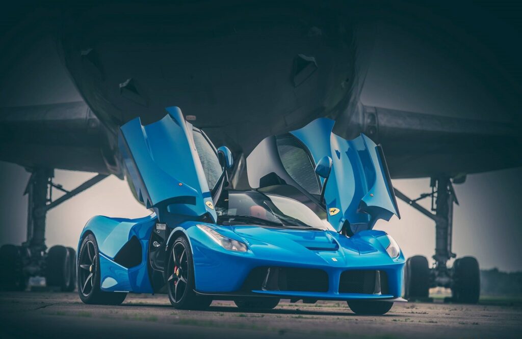Stunning Blue Ferrari LaFerrari with Scissor Doors Against Aircraft Wallpaper