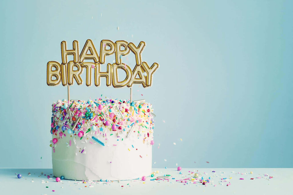 Festive Cake Wallpaper with Colorful Sprinkles on Soft Blue Background