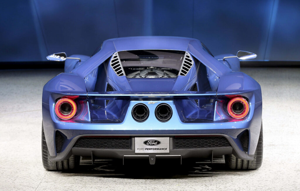 Rear view of blue Ford GT muscle car with aggressive design and bright taillights wallpaper