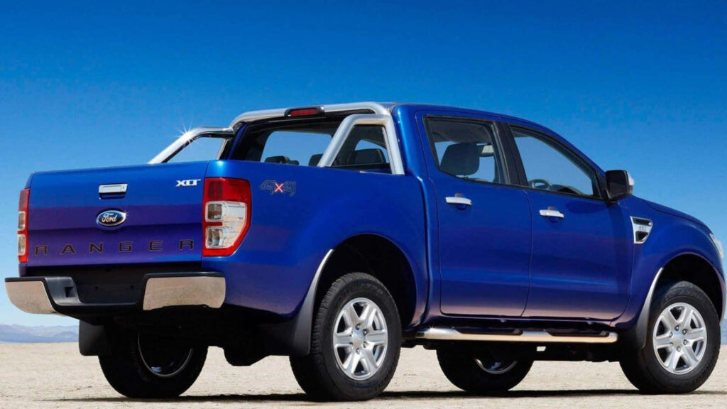 Blue Ford Ranger off-road truck ready for adventure in open rugged landscape under clear sky Wallpaper