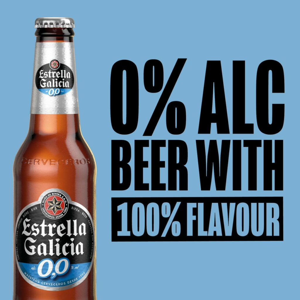 Blue Label Estrella Galicia 00 non alcoholic beer bottle on light blue background full flavor refreshment Wallpaper