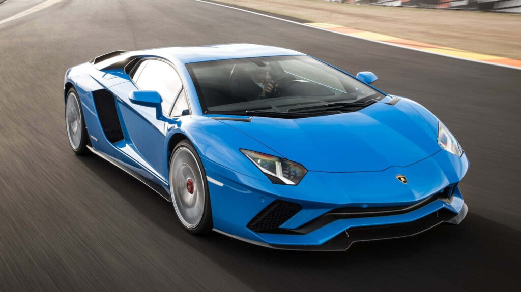 Blue Lamborghini Aventador speeding on track sleek design high performance sports car wallpaper