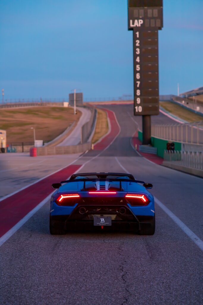 Blue Lamborghini Aventador on Racetrack: Speed & Luxury Wallpaper