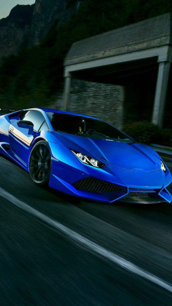 Blue Lamborghini speeding on road luxury sports car dynamic wallpaper background image