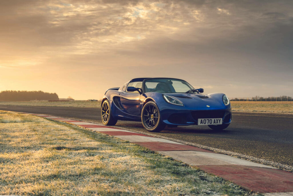 Blue Lotus sports car on racetrack at sunrise showcasing performance and stylish design wallpaper