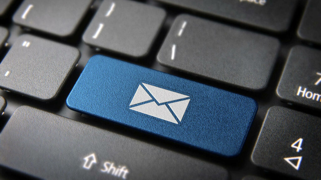 Close-up of computer keyboard with blue key and white mail envelope icon digital communication wallpaper