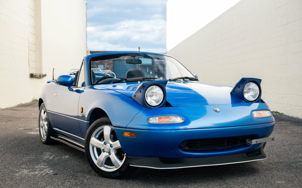 Stunning Blue Mazda MX-5 Wallpaper in Alley - Sleek Roadster Design