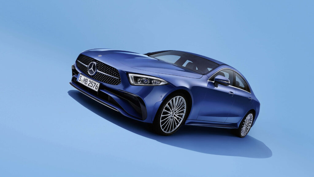 Blue Mercedes-Benz CLS luxury car against smooth light blue background sports elegance wallpaper