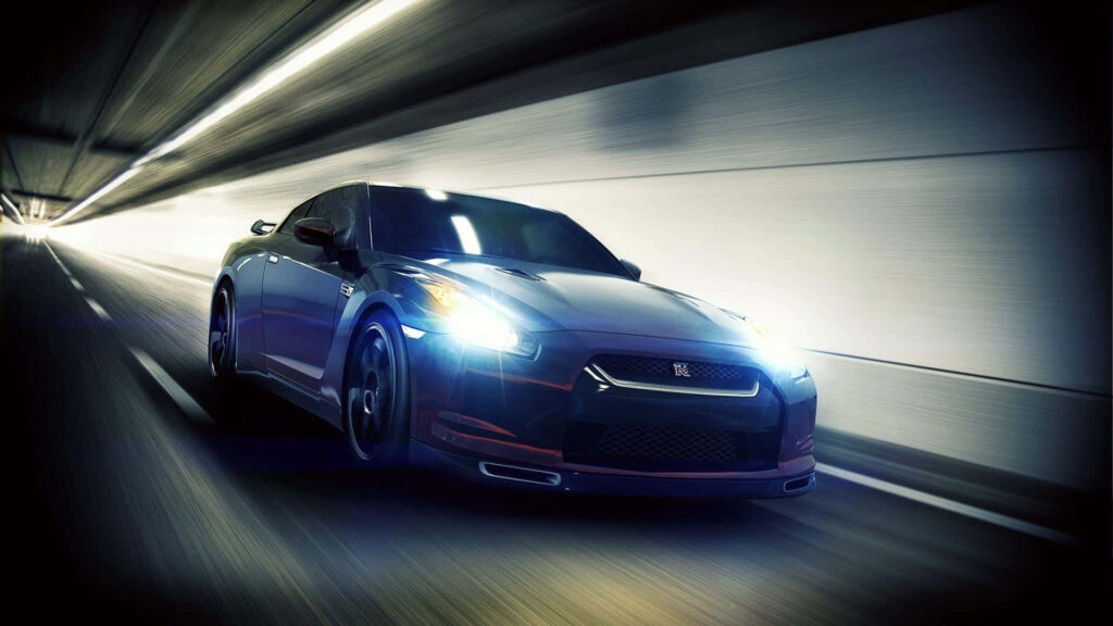 Blue Nissan GT-R speeding through futuristic tunnel with light trails dynamic wallpaper background