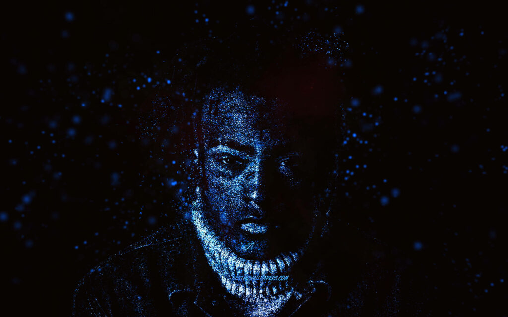 Blue Particle Fusion: Xxxtentacion's Visage Unveiled in an Artistic Computer Wallpaper