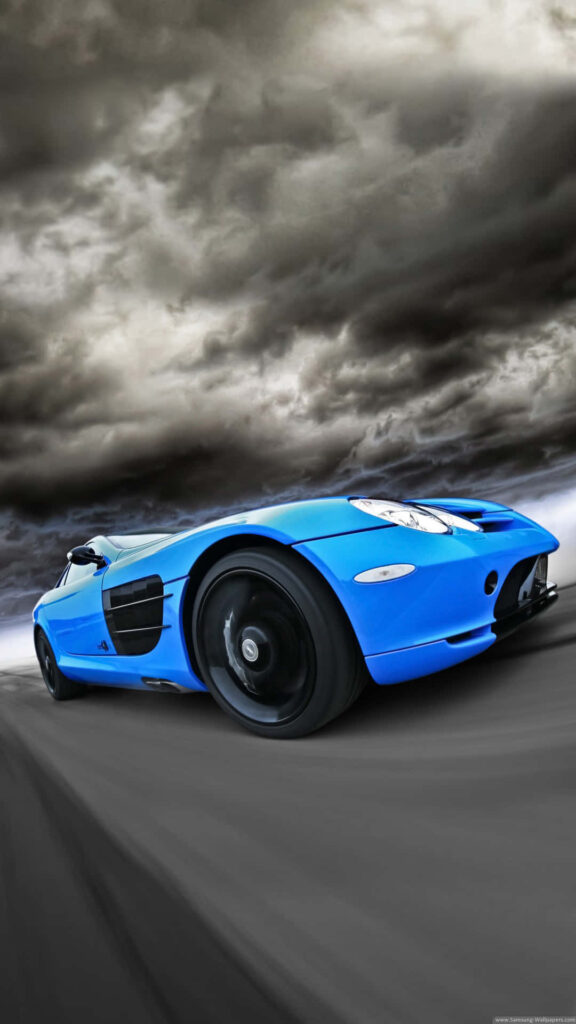 Blue sports car speeding on open road with stormy sky dynamic powerful motion wallpaper