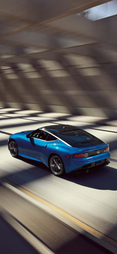 Blue sports car racing on open road high performance driving thrill and elegance wallpaper